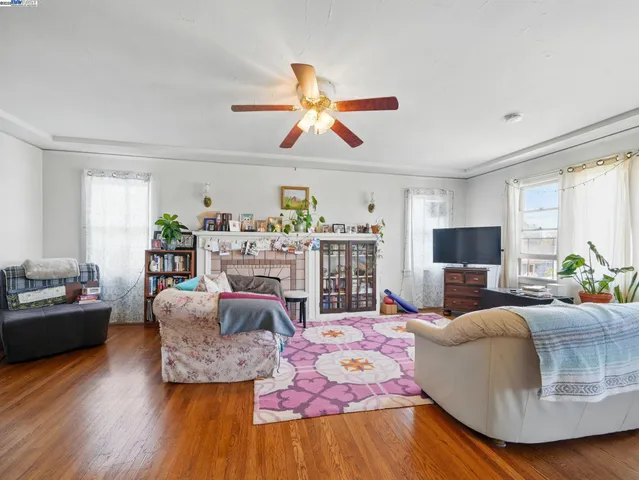 a living room with fireplace furniture and a wooden floor