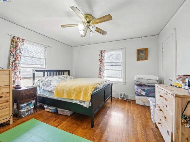 a spacious bedroom with a bed and a table in it