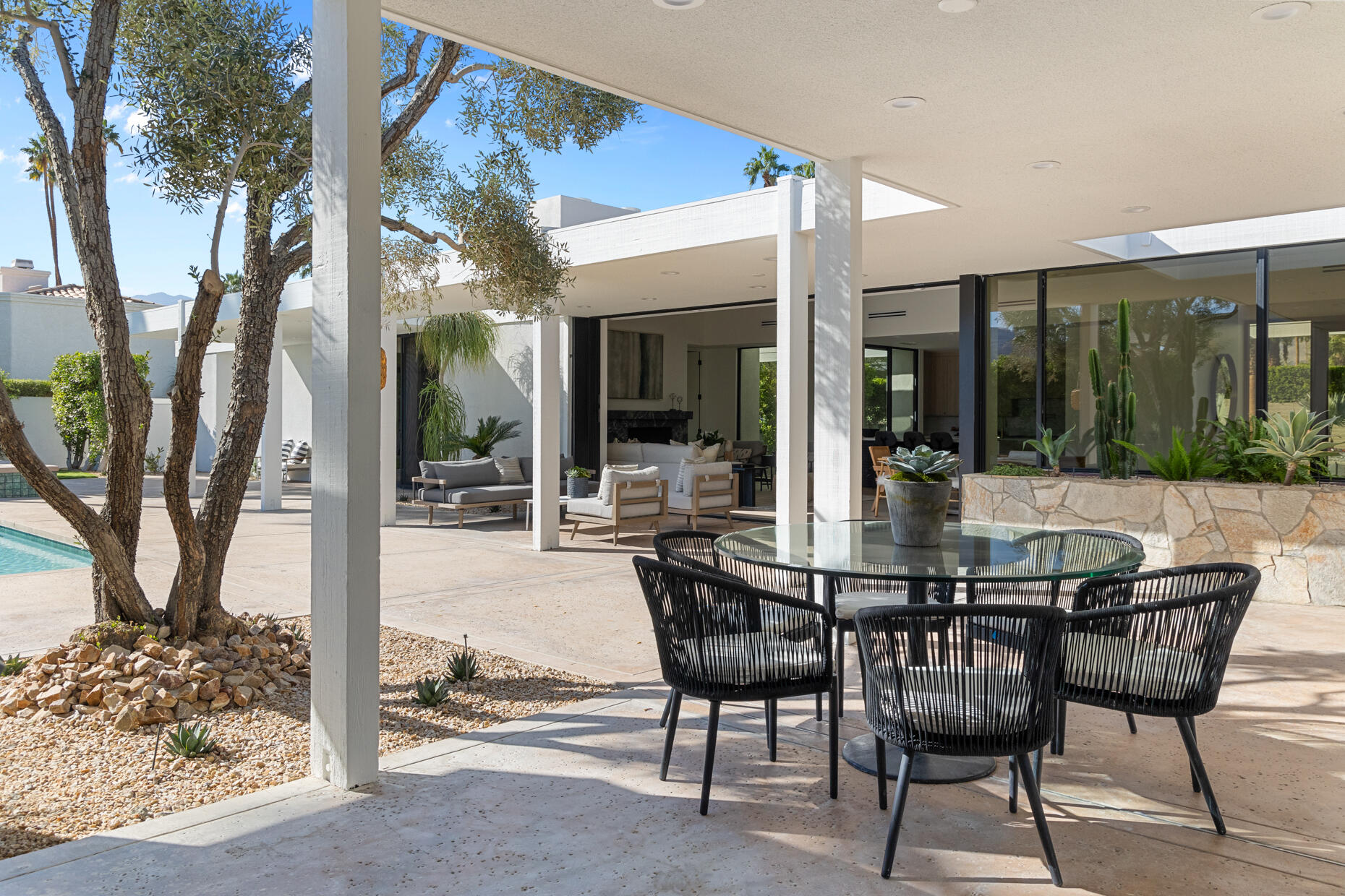 45560 Williams Road Indian Wells, CA 92210 - Photo 55 of 60 a view of a patio with table and chairs and floor to ceiling window