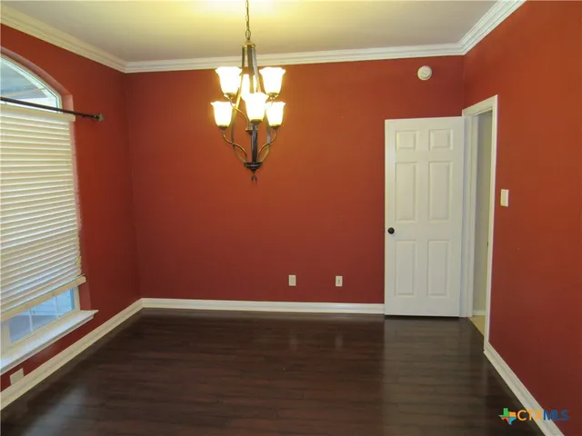 a view of room with window and wooden floor