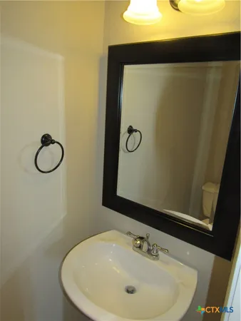 a bathroom with a sink and mirror