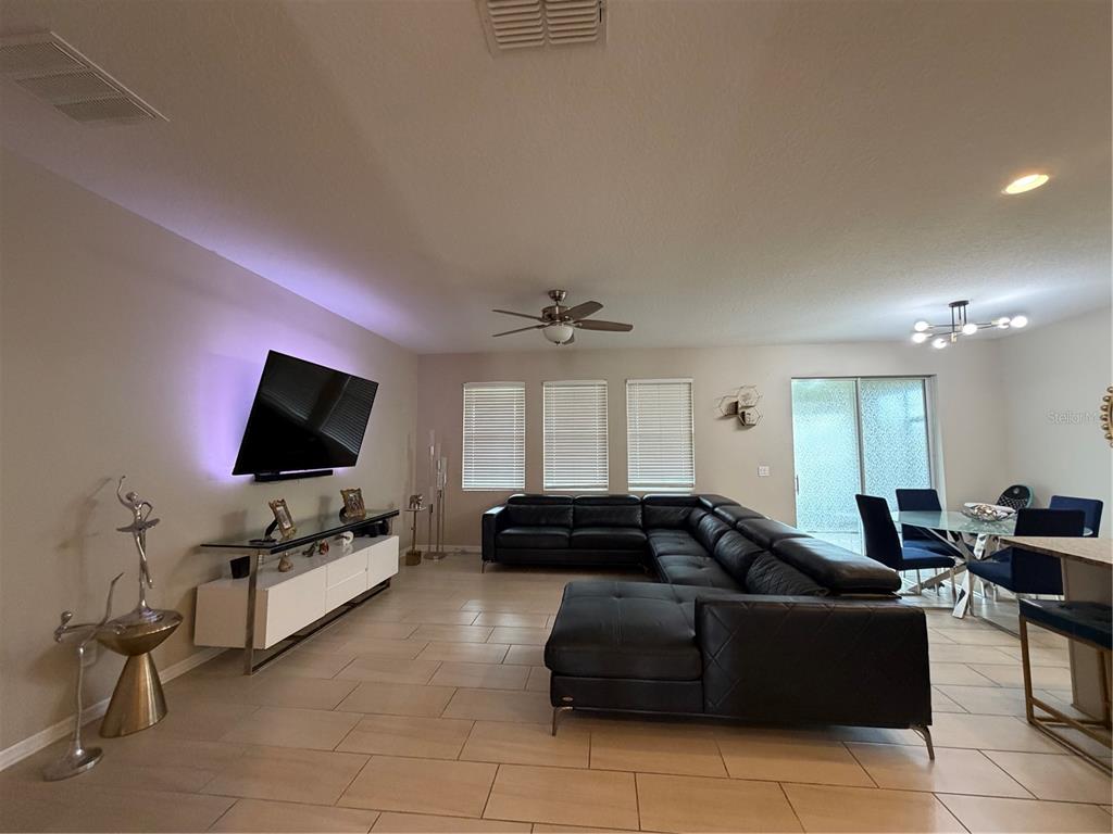 1834 Castleton Drive St. Cloud, FL 34771 - Photo 12 of 33 a living room with furniture and a flat screen tv