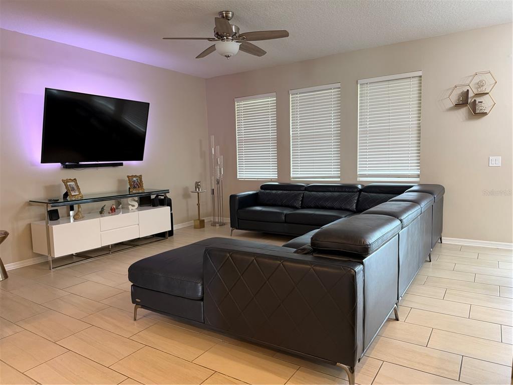1834 Castleton Drive St. Cloud, FL 34771 - Photo 13 of 33 a living room with furniture and a flat screen tv
