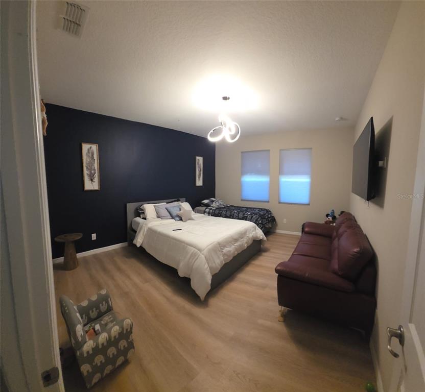 1834 Castleton Drive St. Cloud, FL 34771 - Photo 14 of 33 a spacious bedroom with a bed window and couch