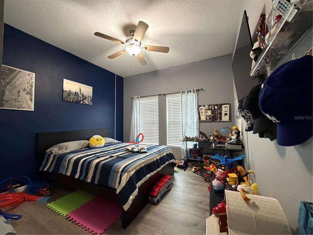 1834 Castleton Drive St. Cloud, FL 34771 - Photo 17 of 33 a bedroom with bed and a chandelier