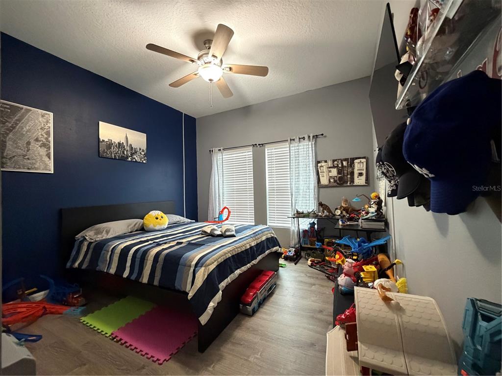 1834 Castleton Drive St. Cloud, FL 34771 - Photo 18 of 33 a bedroom with bed and a chandelier