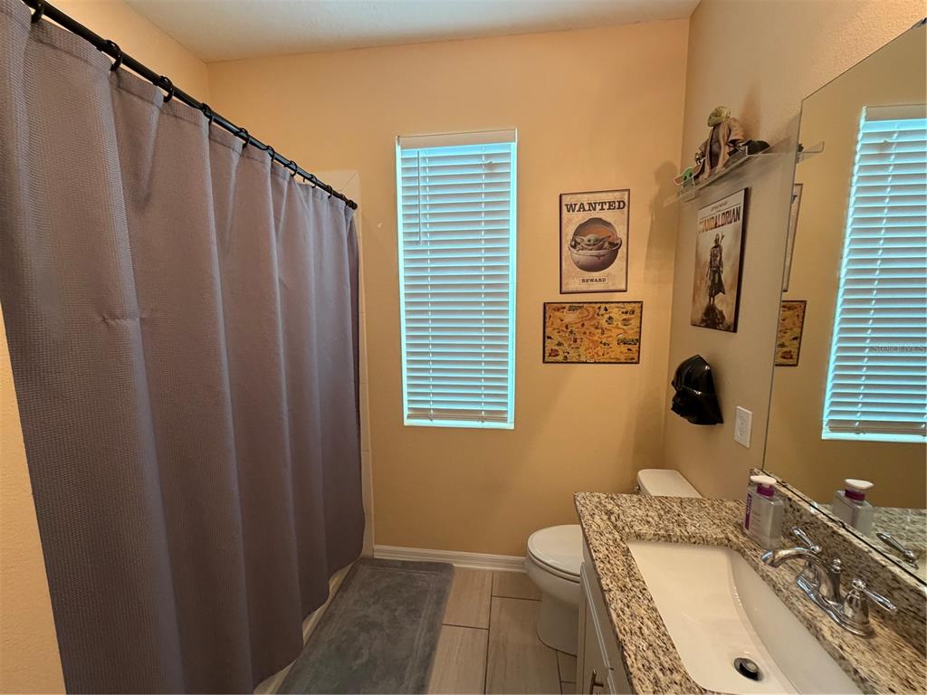 1834 Castleton Drive St. Cloud, FL 34771 - Photo 21 of 33 a bathroom with a tub sink and mirror