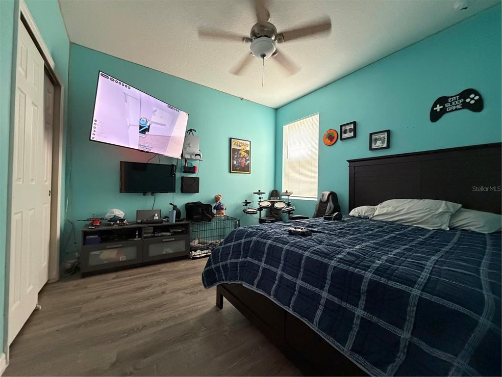 1834 Castleton Drive St. Cloud, FL 34771 - Photo 23 of 33 a bedroom with bed mirror and dresser