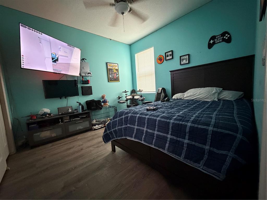 1834 Castleton Drive St. Cloud, FL 34771 - Photo 24 of 33 a bedroom with a bed window and a flat screen tv