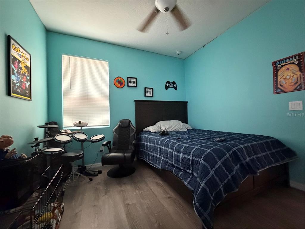 1834 Castleton Drive St. Cloud, FL 34771 - Photo 25 of 33 a bedroom with a bed and a desk