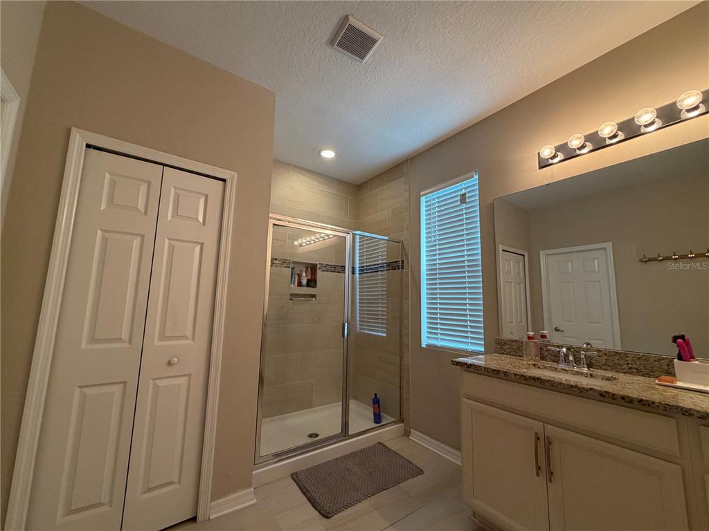 1834 Castleton Drive St. Cloud, FL 34771 - Photo 30 of 33 a bathroom with a double vanity sink and a mirror