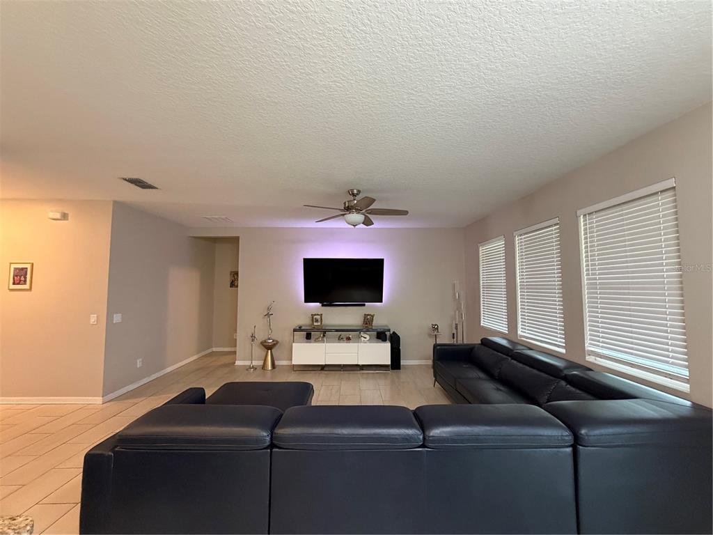 1834 Castleton Drive St. Cloud, FL 34771 - Photo 10 of 33 a living room with furniture and a flat screen tv