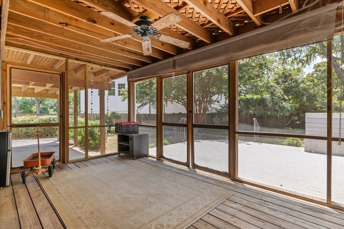 a view of a room with wooden floor and furniture