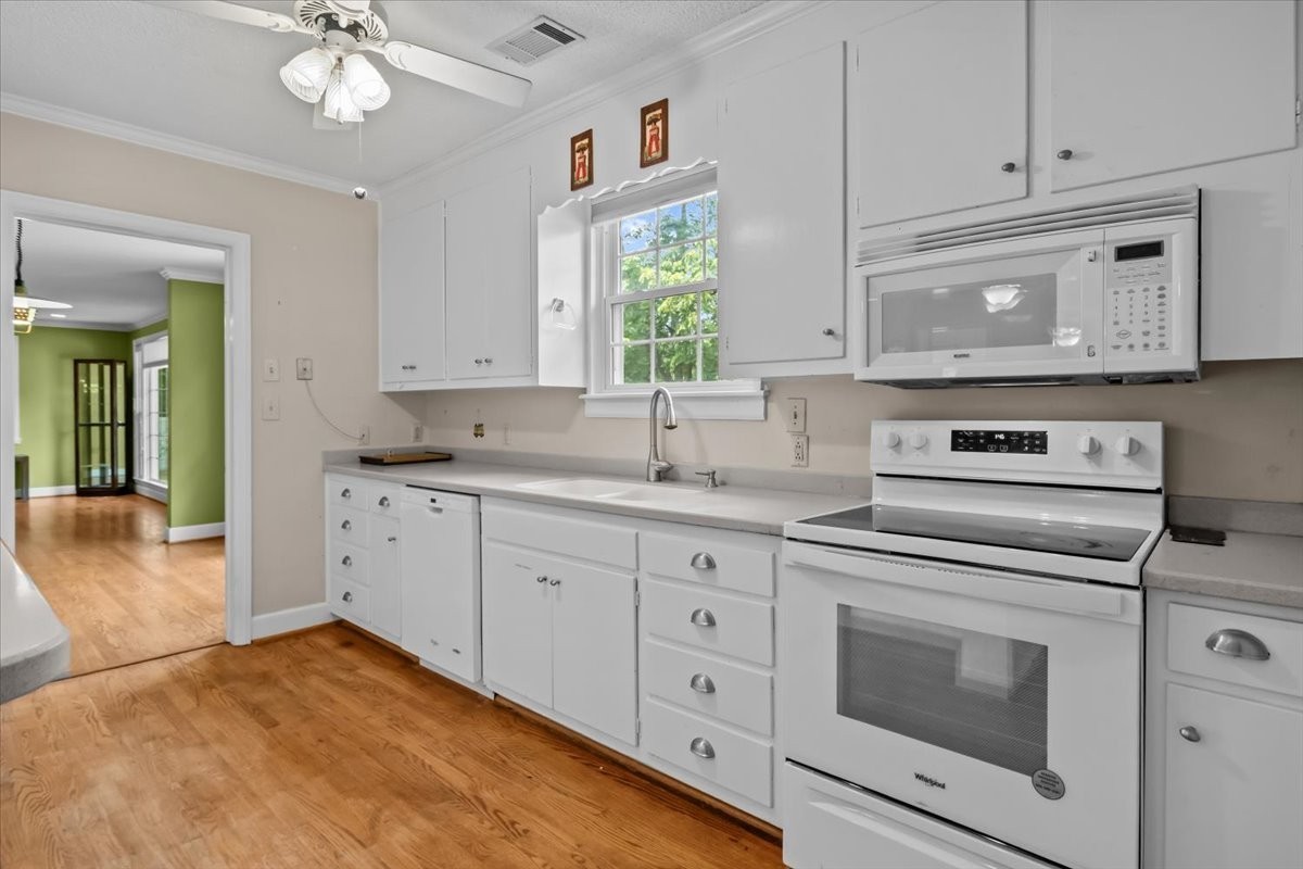935 Evans Road Nashville, TN 37204 - Photo 15 of 44 a kitchen with granite countertop white cabinets and white appliances