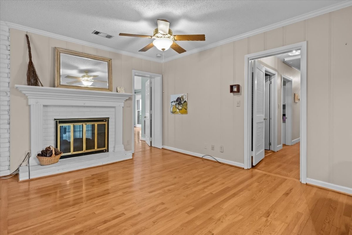 935 Evans Road Nashville, TN 37204 - Photo 8 of 44 a view of an empty room with wooden floor and a fireplace