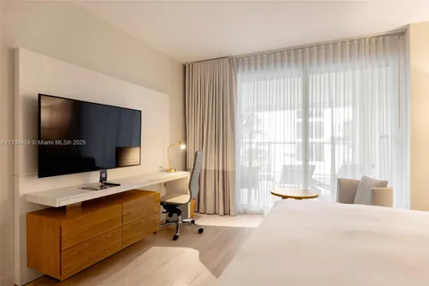 a living room with a large window and a flat screen tv