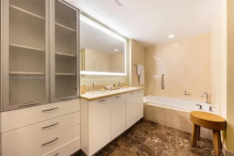 a bathroom with a bathtub sink and mirror