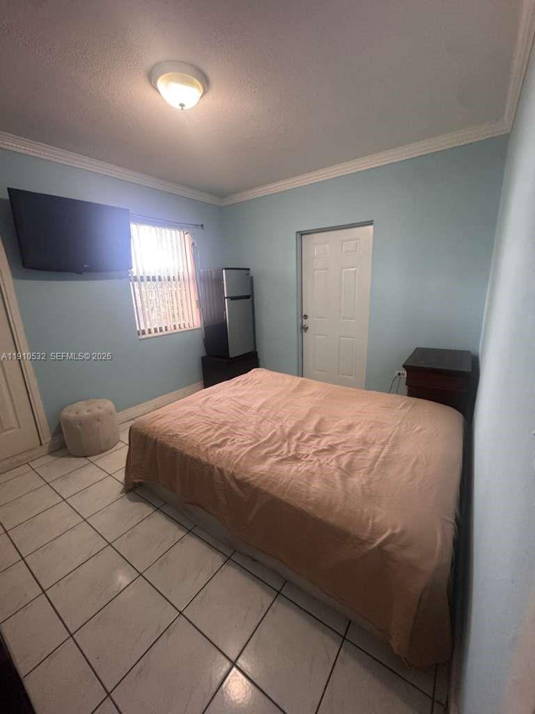 14800 Southwest 296th Street Homestead, FL 33033 - Photo 15 of 28 a bedroom with a bed and a window