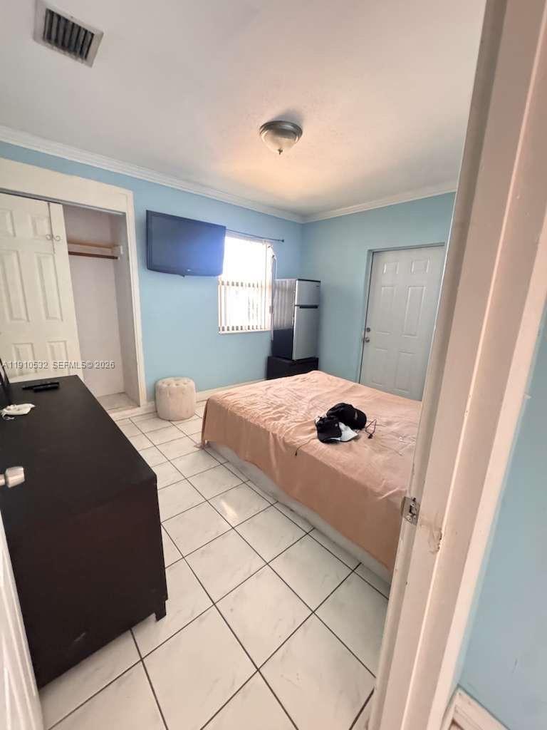 14800 Southwest 296th Street Homestead, FL 33033 - Photo 22 of 28 a bedroom with a bed and a large window