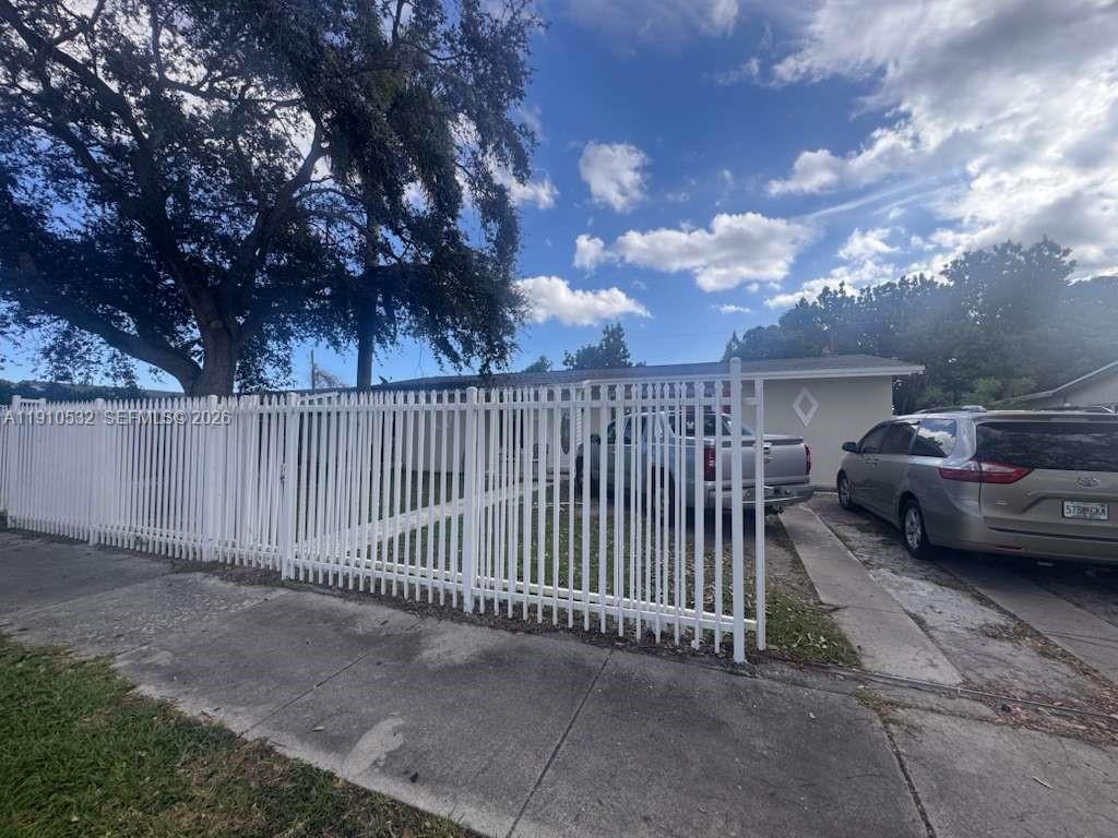 14800 Southwest 296th Street Homestead, FL 33033 - Photo 5 of 28 a view of a street with a car parked side of it