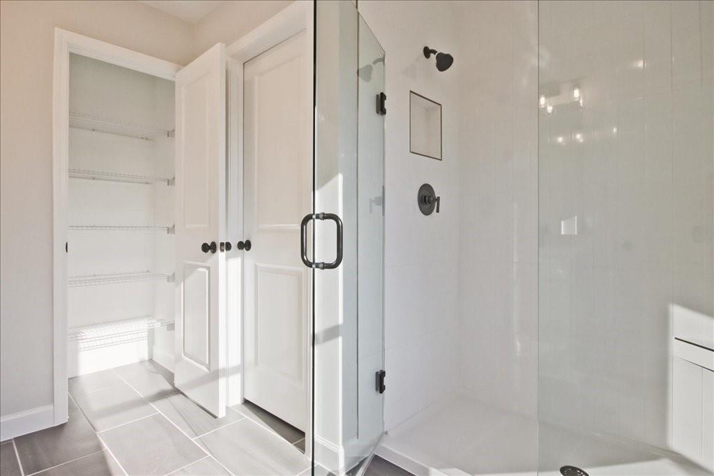 313 Colsen Drive Acworth, GA 30102 - Photo 2 of 37 a bathroom with a glass shower door
