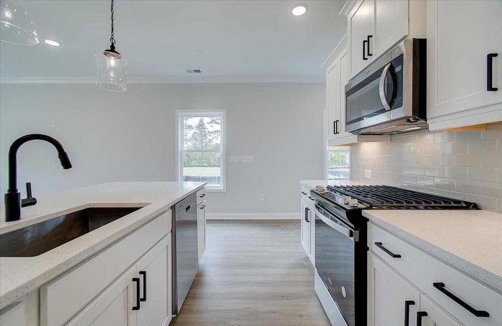 313 Colsen Drive Acworth, GA 30102 - Photo 21 of 37 a kitchen with stainless steel appliances granite countertop a sink a stove and a microwave