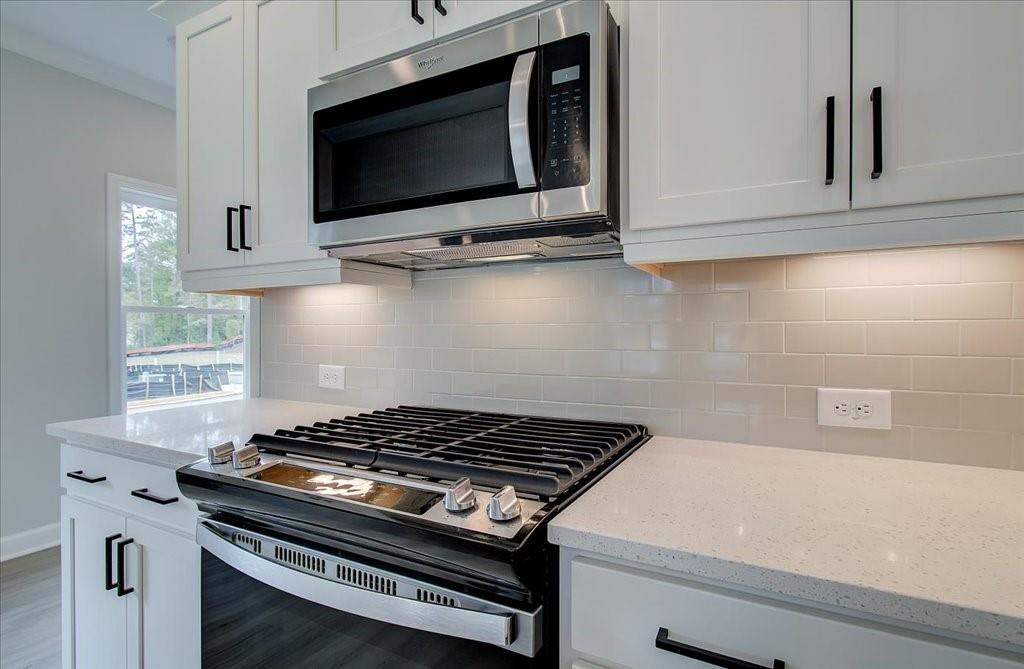 313 Colsen Drive Acworth, GA 30102 - Photo 22 of 37 a stove top oven sitting inside of a kitchen