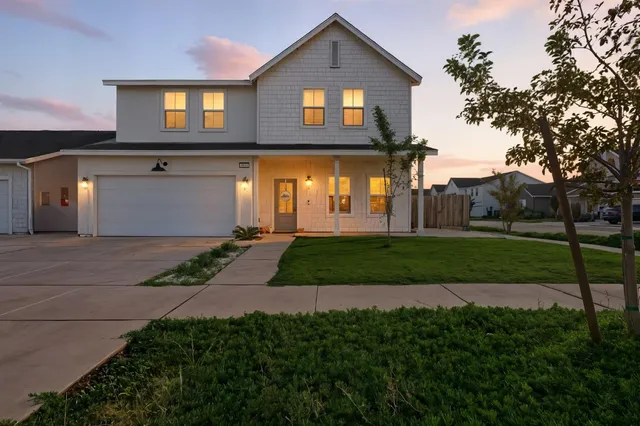 a front view of a house with a yard