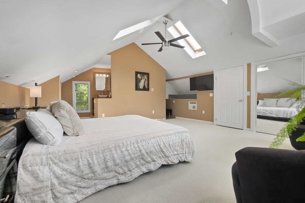 11 Bartlett Place Amesbury, MA 01913 - Photo 22 of 41 a bedroom with a bed and a chandelier