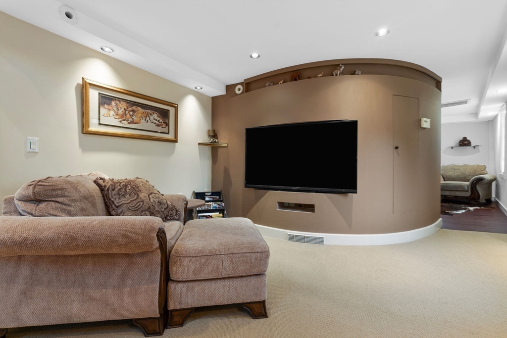 11 Bartlett Place Amesbury, MA 01913 - Photo 24 of 41 a living room with furniture and a flat screen tv