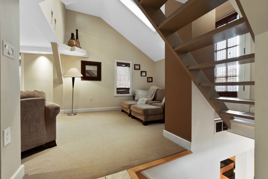 11 Bartlett Place Amesbury, MA 01913 - Photo 26 of 41 a living room with furniture and a staircase