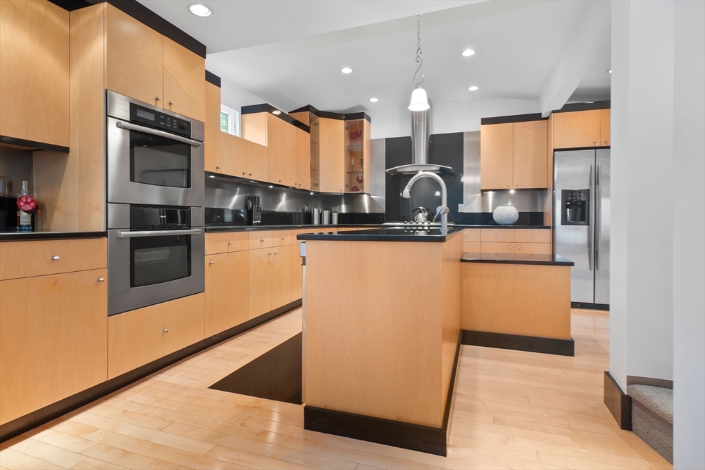 11 Bartlett Place Amesbury, MA 01913 - Photo 4 of 41 a kitchen with stainless steel appliances granite countertop a stove a sink and a microwave