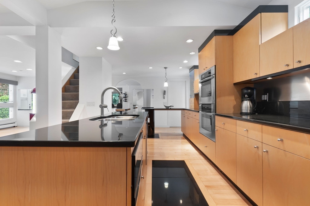 11 Bartlett Place Amesbury, MA 01913 - Photo 8 of 41 a large kitchen with kitchen island a large counter top space a sink stainless steel appliances and cabinets