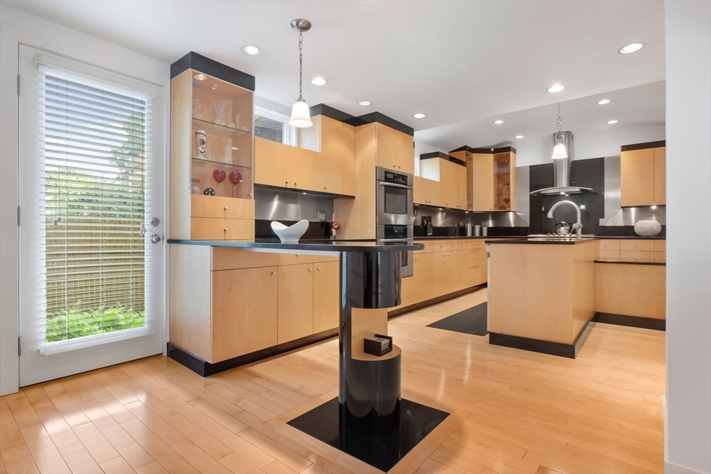 11 Bartlett Place Amesbury, MA 01913 - Photo 9 of 41 a kitchen with stainless steel appliances granite countertop a sink a stove and a refrigerator