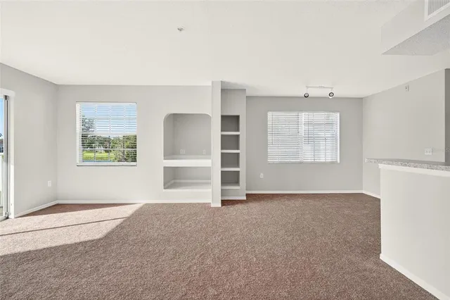 a kitchen with stainless steel appliances granite countertop a sink and a microwave
