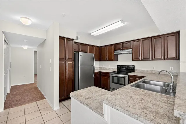 an empty room with a ceiling fan and a window