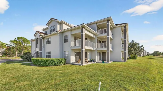a front view of a building with a garden