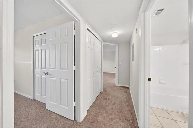 an aerial view of residential houses with outdoor space and lake view