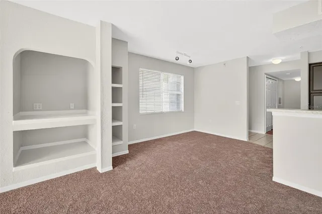 a kitchen with granite countertop a refrigerator and a sink