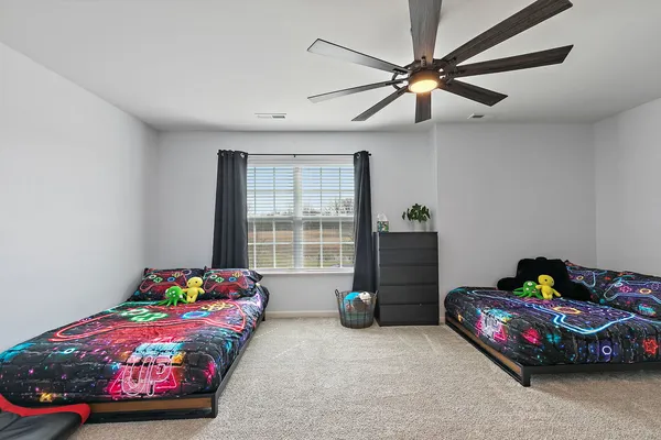a bedroom with a bed and a chandelier