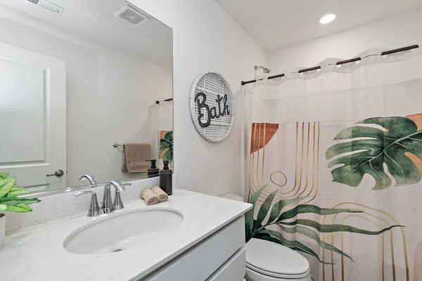 a bathroom with a sink a mirror and a toilet