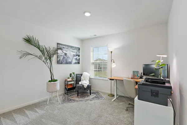 a living room with furniture a piano and a flat screen tv