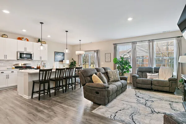 a living room with furniture and a large window