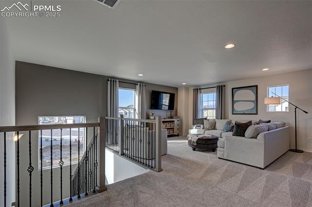 5057 Truscott Road Colorado Springs, CO 80925 - Photo 3 of 48 Carpeted living room with a wealth of natural light