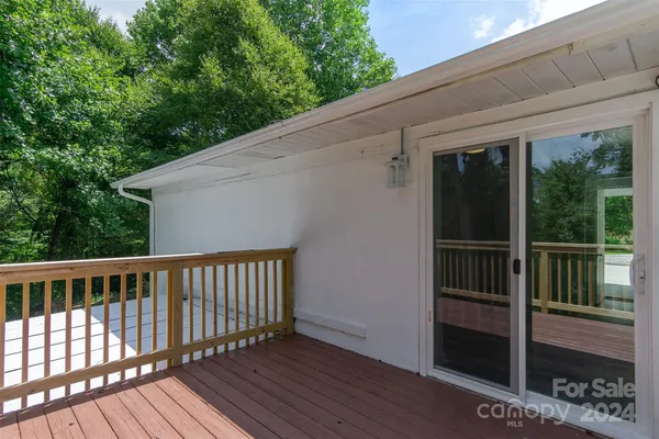 a view of balcony with wooden floor