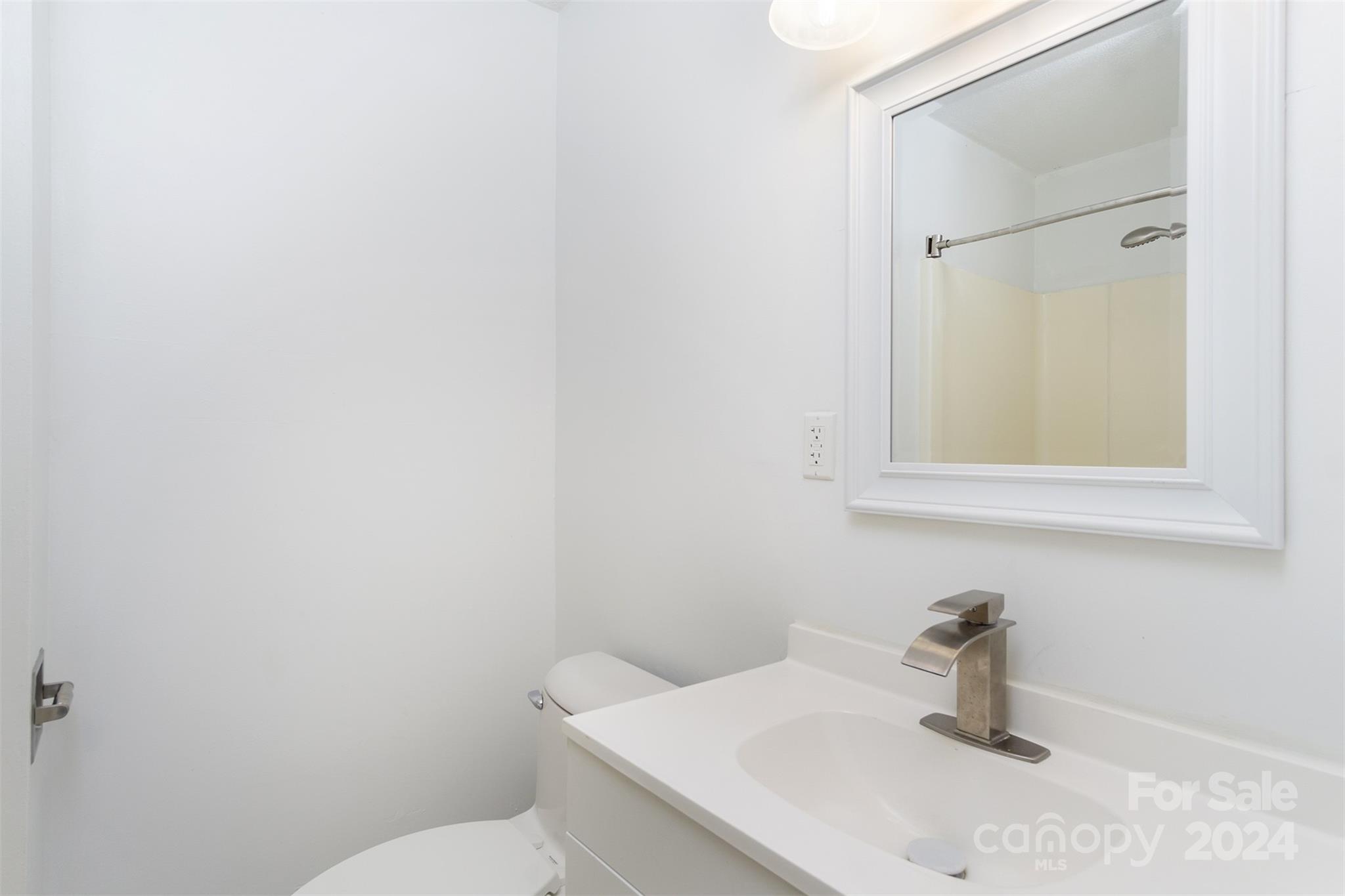 468 Deer Park Lake Road Spruce Pine, NC 28777 - Photo 14 of 46 a bathroom with a sink a toilet and mirror