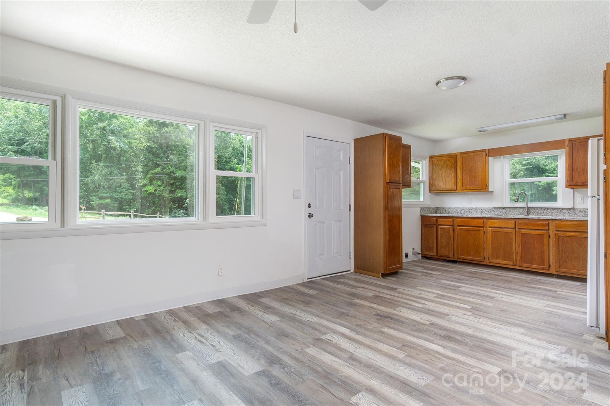 468 Deer Park Lake Road Spruce Pine, NC 28777 - Photo 16 of 46 a view of a kitchen with wooden floor and a window