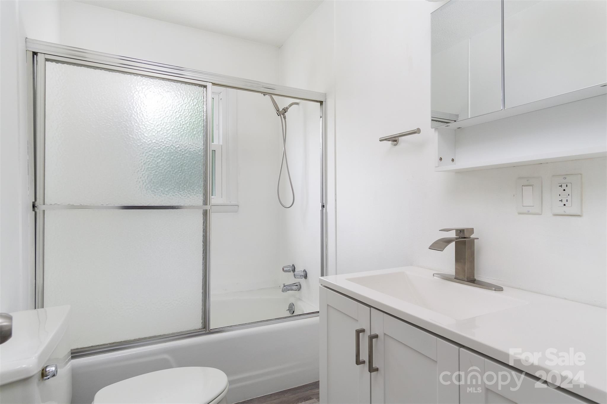 468 Deer Park Lake Road Spruce Pine, NC 28777 - Photo 19 of 46 a bathroom with a sink a toilet and shower