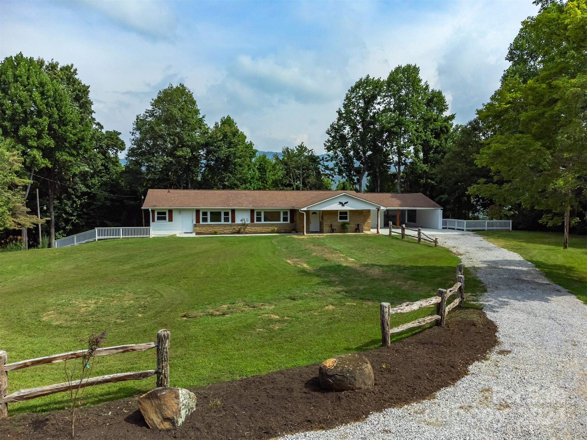 468 Deer Park Lake Road Spruce Pine, NC 28777 - Photo 2 of 46 a front view of a house with garden
