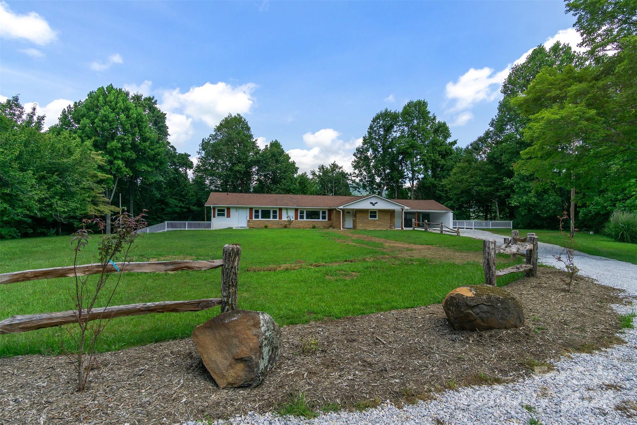 468 Deer Park Lake Road Spruce Pine, NC 28777 - Photo 21 of 46 a view of a garden with a slide and a lake view